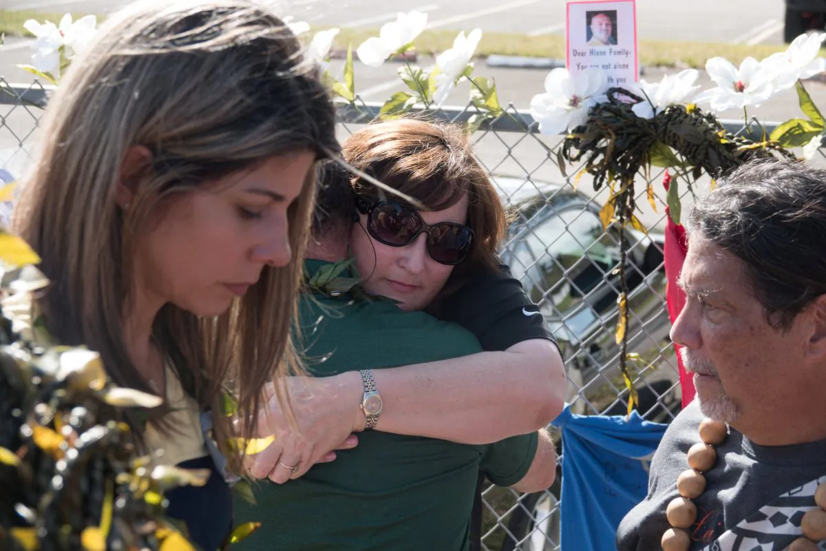 Parkland Mayor Christine Hunschofsky receives a hug as she and other government officials mourn, as students and parents arrive for voluntary campus orientation at the Marjory Stoneman Douglas High School, Feb. 25, 2018. (Reuters/Angel Valentin)