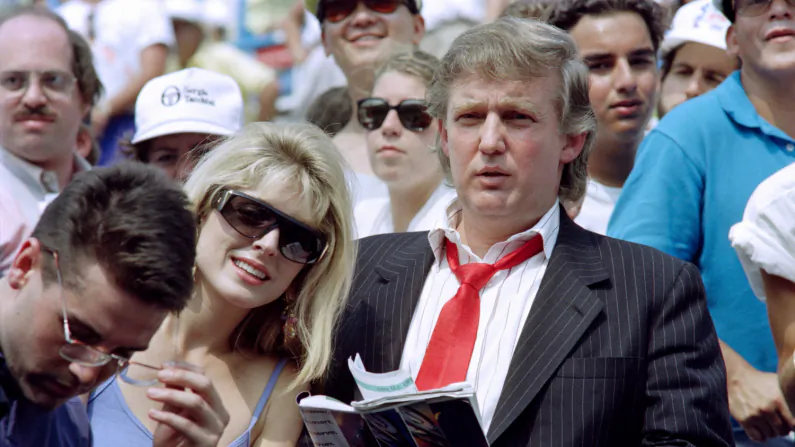 Donald Trump (R) and his fiancee Marla Maples watch second round action at the US Open tennis tournament on August 28, 1991.
 (Timothy A. Clary/AFP/Getty Images)