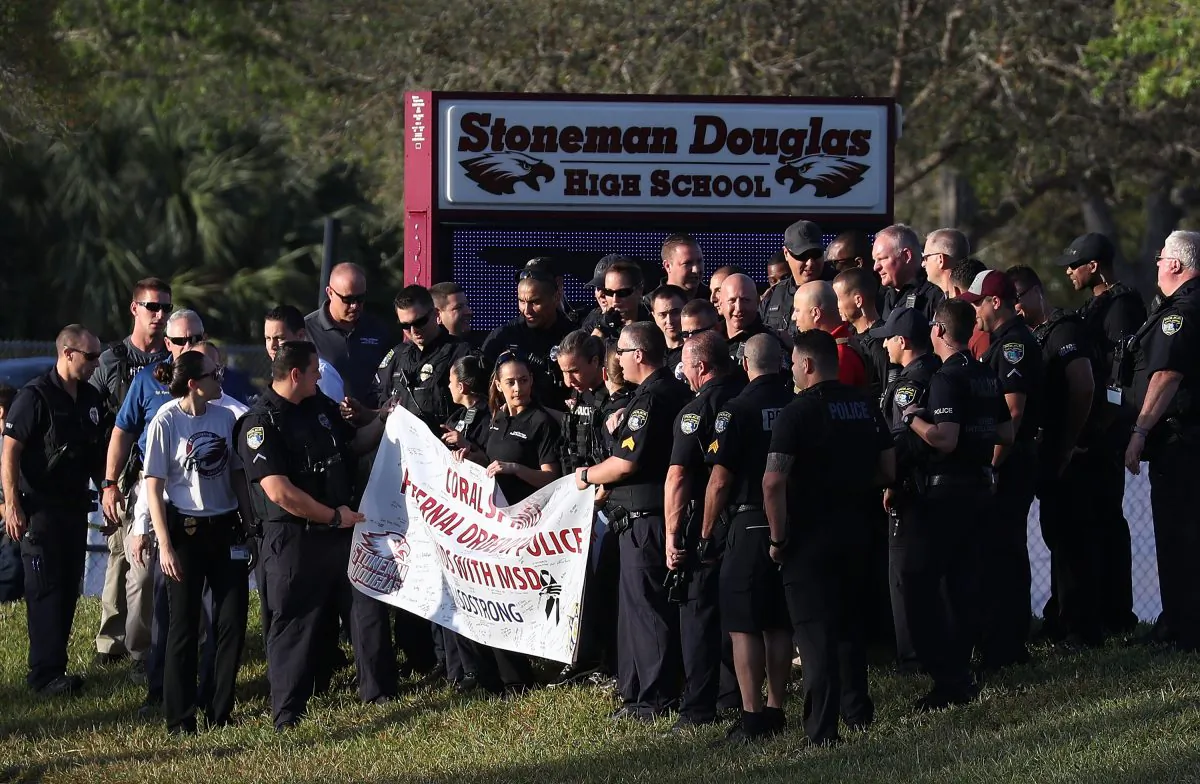 Police officers stand in front of Marjory Stoneman Douglas High School as students arrive to attend classes for the first time since the shooting that killed 17 people on Feb. 14,  at the school on Feb. 28, 2018 in Parkland, Florida.  In the wake of the mass shooting the nation is engaged in an intense discussion about how to improve school security. (Joe Raedle/Getty Images)