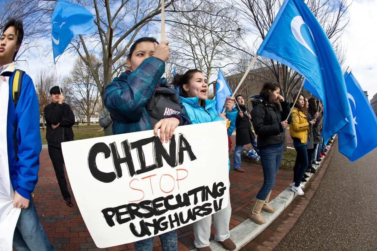 Uyghur activists protest against the visit of Chinese regime head Hu Jintao outside of the White House in Washington, DC, on Jan. 19, 2011. A new report says that Uyghurs across the world, including many in the United States, are being spied on by China’s intelligence services. (Nicholas Kamm/AFP/Getty Images)