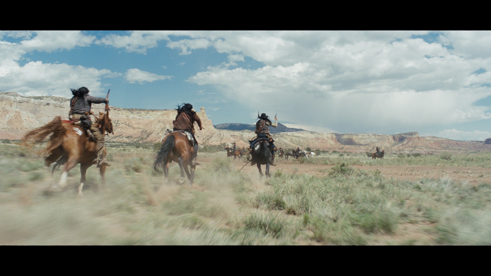 men on horseback galloping in hostiles