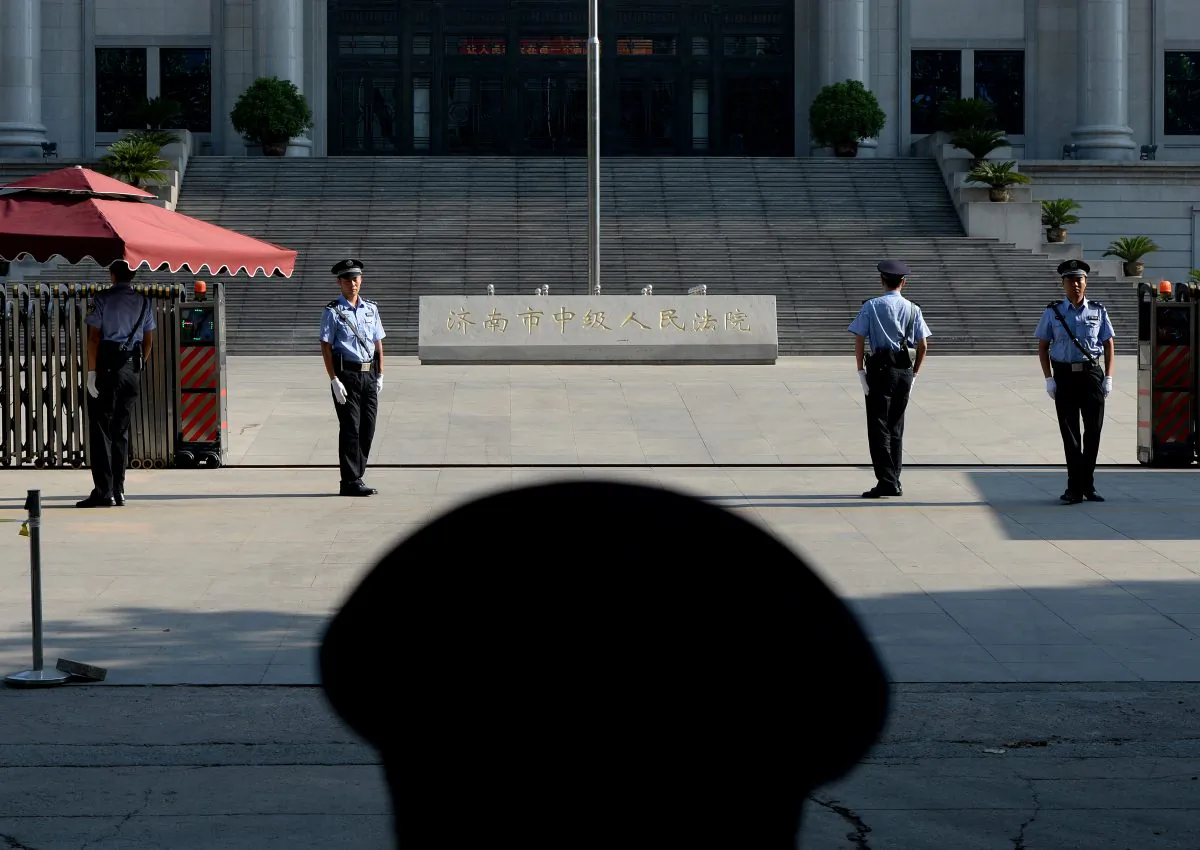 Police patrol outside the Intermediate People's Court in Jinan City, Shandong Province, China, on Aug. 26, 2013. (Mark Ralston/AFP/Getty Images)