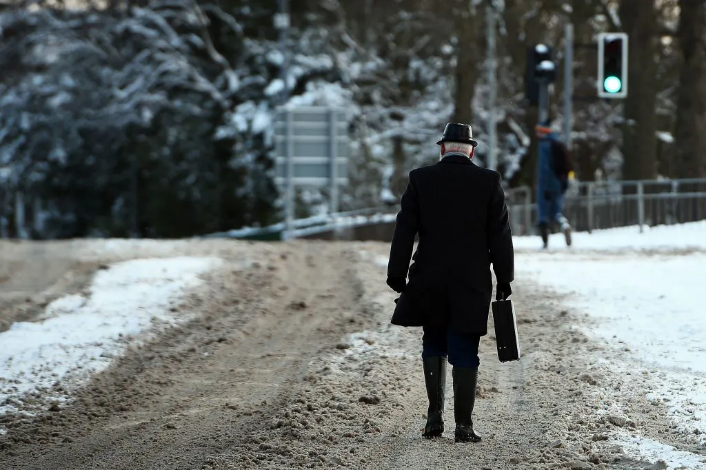 A man walks to work down empty streets in Glasgow after snow covered the city on March 1, 2018. (Andy Buchanan/AFP/Getty Images)