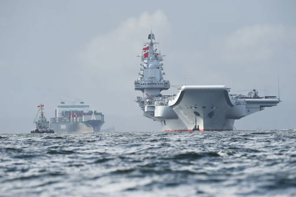 China's sole aircraft carrier, the Liaoning (R), arrives in Hong Kong waters on July 7, 2017. 
(Anthony Wallace/AFP/Getty Images)