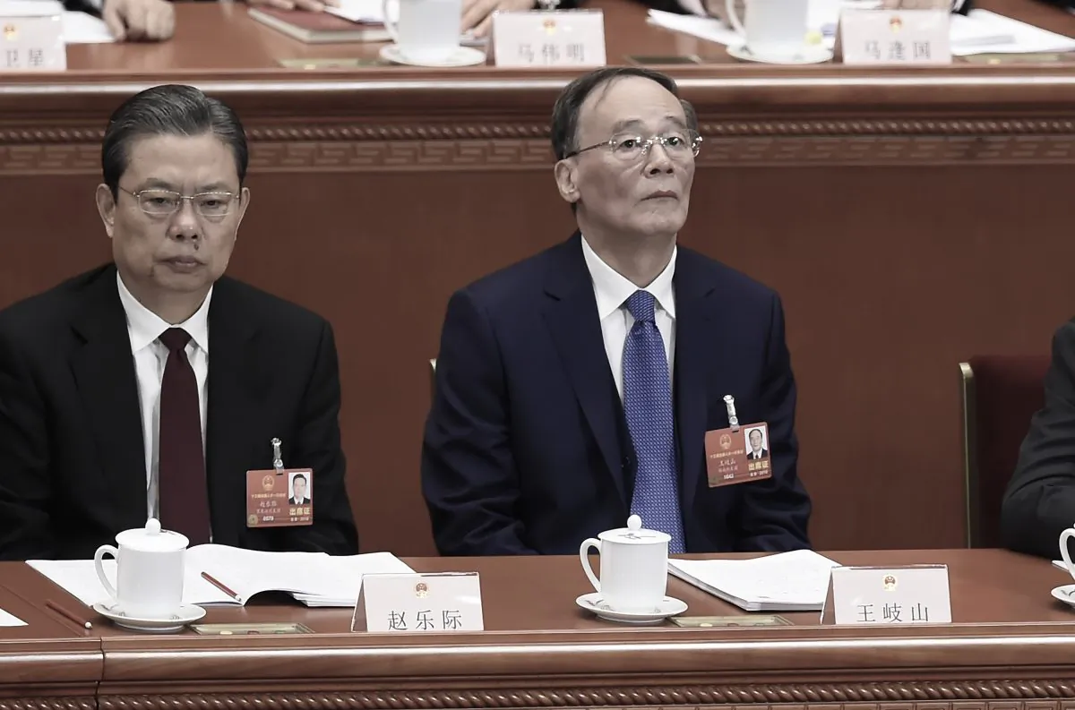 Wang Qishan (R), former head of the Chinese Communist Party's anti-corruption agency, attends the opening session of the National People's Congress, China's rubber-stamp legislature, in Beijing on March 5, 2018. (Wang Zhao/AFP/Getty Images)