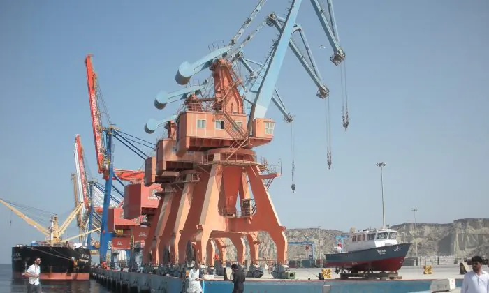 Laborers walk through the Gwadar Port in Pakistan, a multi-billion dollar infrastructure project that China has invested in, as part of the latter's 'One Belt, One Road' initiative. (Amelie Herenstein/AFP/Getty Images)