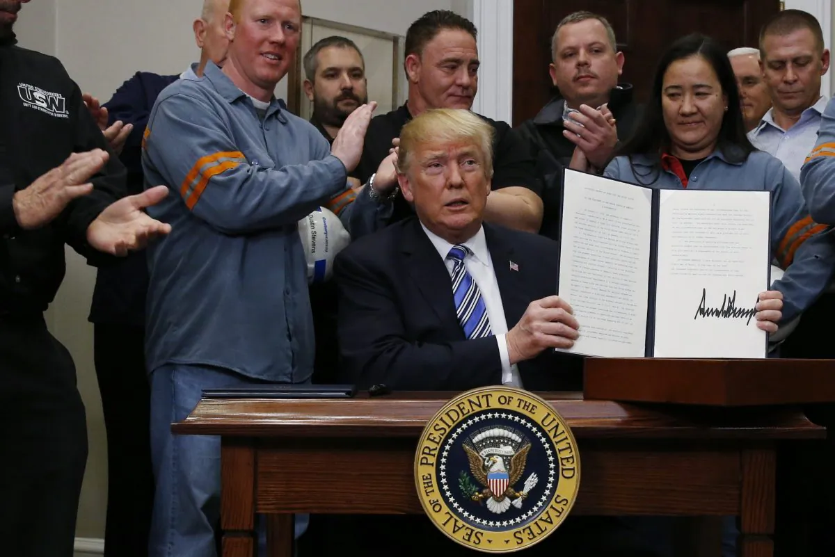 U.S. President Donald Trump holds up a proclamation during a White House ceremony to establish tariffs on imports of steel and aluminum at the White House in Washington on March 8, 2018. (Reuters/Leah Millis)