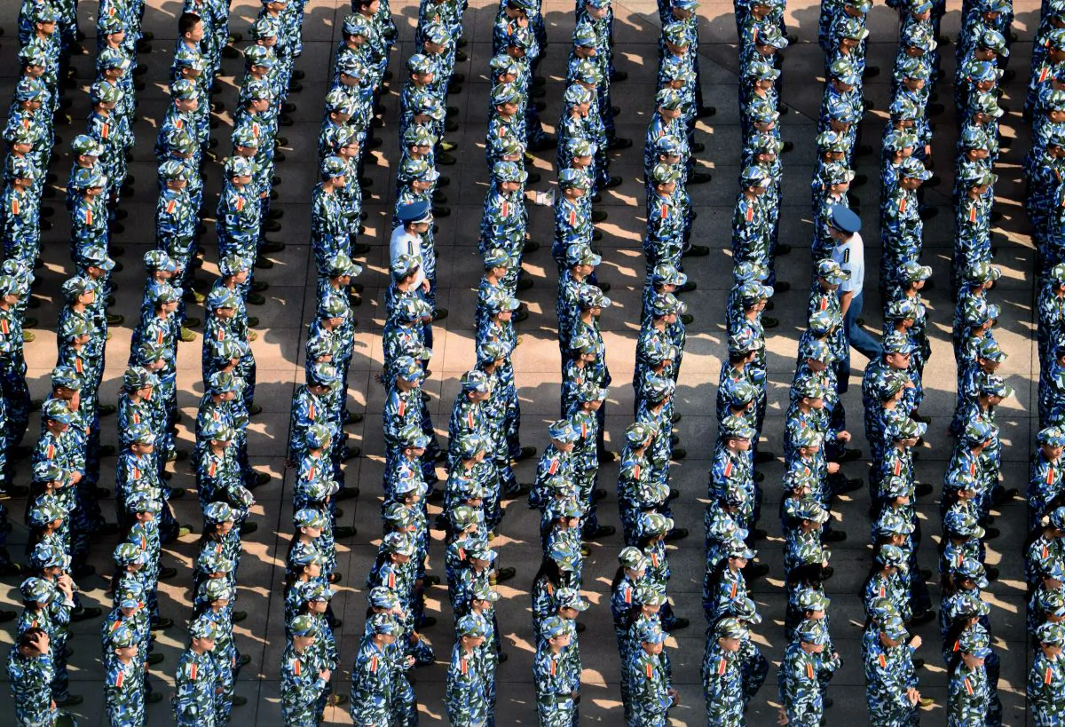 About 7,000 freshmen wearing fatigues gather at the Wuhan University of Technology during a military training in Wuhan City, Hubei Province on Sept. 14, 2015.  (VCG via Getty Images)