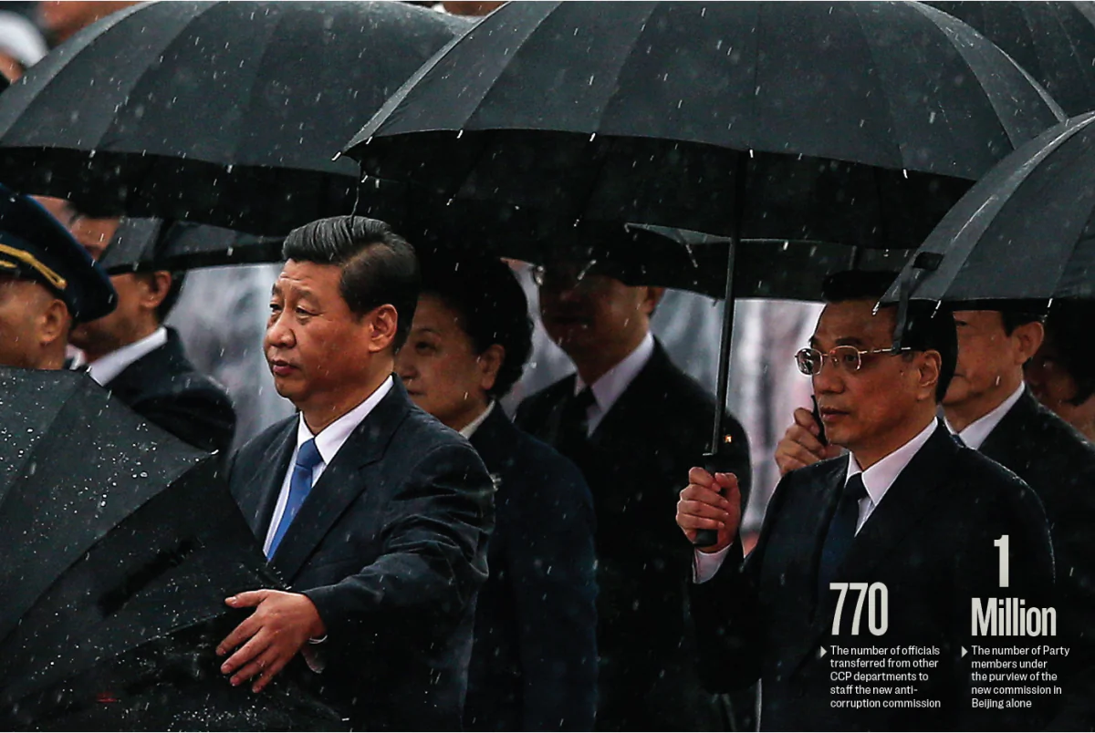 Chinese leader Xi Jinping (front, L), Premier Li Keqiang (front, R), and other Chinese Communist Party top officials stand in the rain during a ceremony marking the 64th anniversary of the Party’s takeover of China, at Tiananmen Square in Beijing on Oct. 1, 2013. (FENG LI/GETTY IMAGES) 