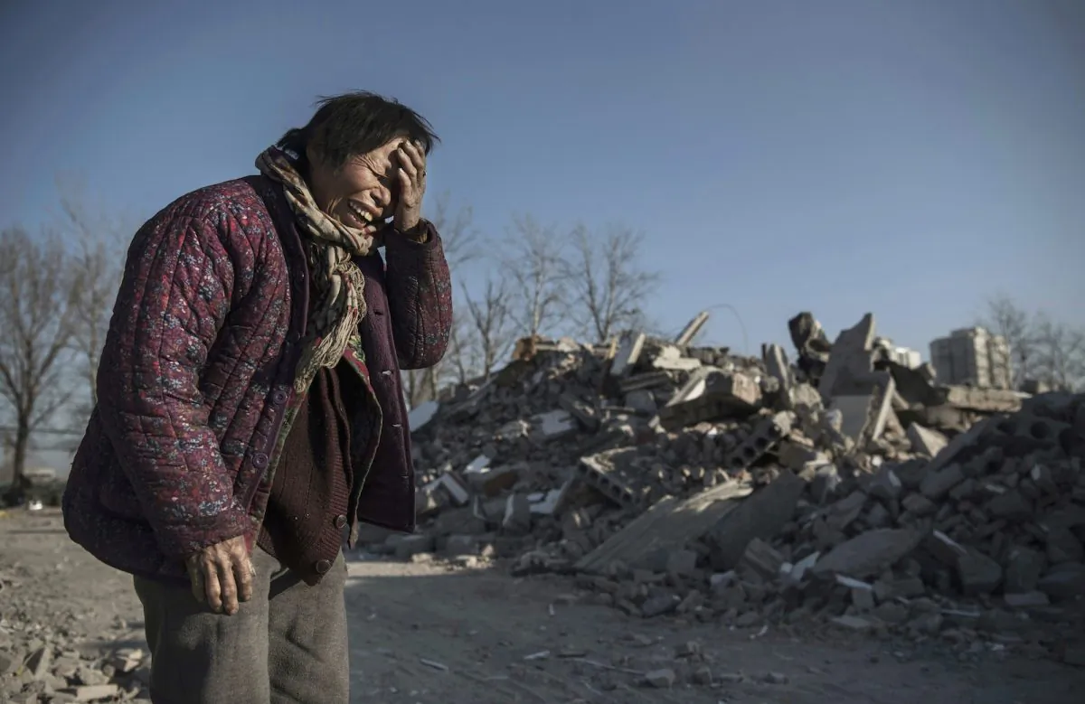 Zheng Yuzhi, whose apartment was demolished by authorities three months ago and is now homeless, in an area once filled with housing for migrant workers, in the Changing District of Beijing, China, on December 5, 2017. (Kevin Frayer/Getty Images)