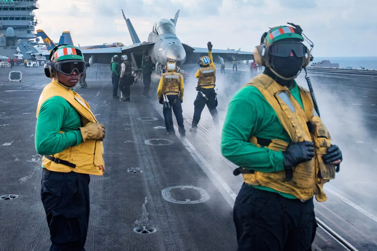 U.S. Sailors conduct flight operations on the aircraft carrier USS Carl Vinson (CVN 70) flight deck in South China Sea on April 8, 2017. (Mass Communication Specialist 3rd Class Matt Brown/U.S. Navy via Getty Images)