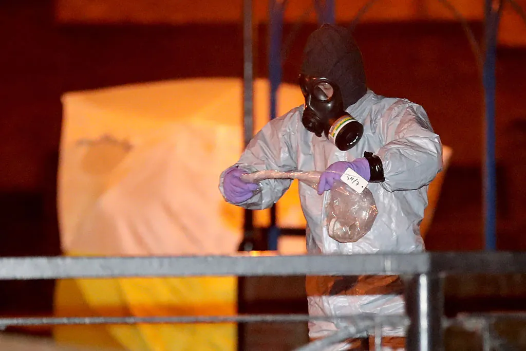 Police officers in forensics suits and protective masks work at the scene of the poisoning of Sergei Skripal on March 13, 2018 in Salisbury, England. (Christopher Furlong/Getty Images)