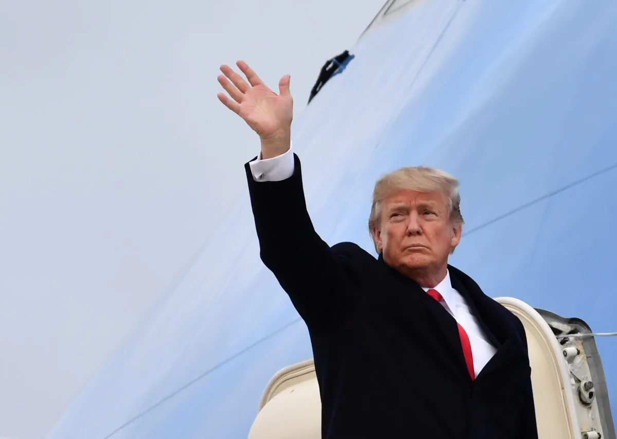 US President Donald Trump waves before boarding the Air Force One ahead of his departure from Zurich Airport in Zurich on Jan. 26, 2018. (Nicholas Kamm/AFP/Getty Images)