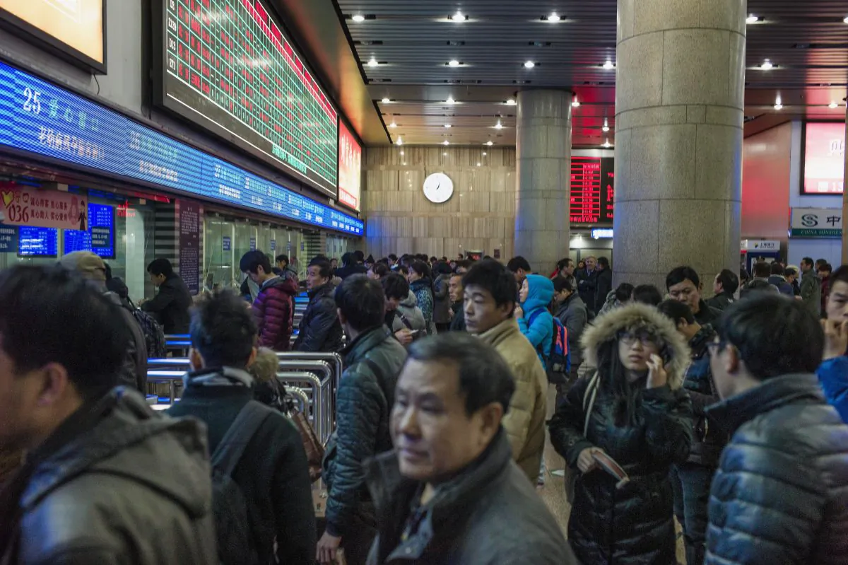 Chinese travelers queue to buy train tickets to head home for the Lunar New Year at the Beijing Train Station on Feb. 4, 2015. (Fred Dufour/AFP/Getty Images)