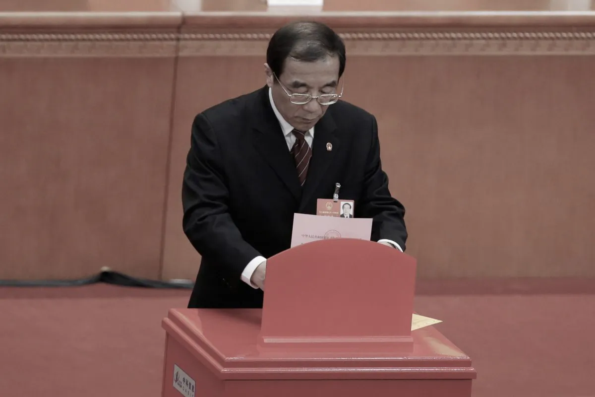 Yang Xiaodu, the newly appointed head of the anti-corruption super agency, the National Supervision Commission, drops his ballot during a session of the rubber-stamp parliament, the National People's Congress, at the Great Hall of the People in Beijing, China, on March 18, 2018. (Jason Lee/Reuters)