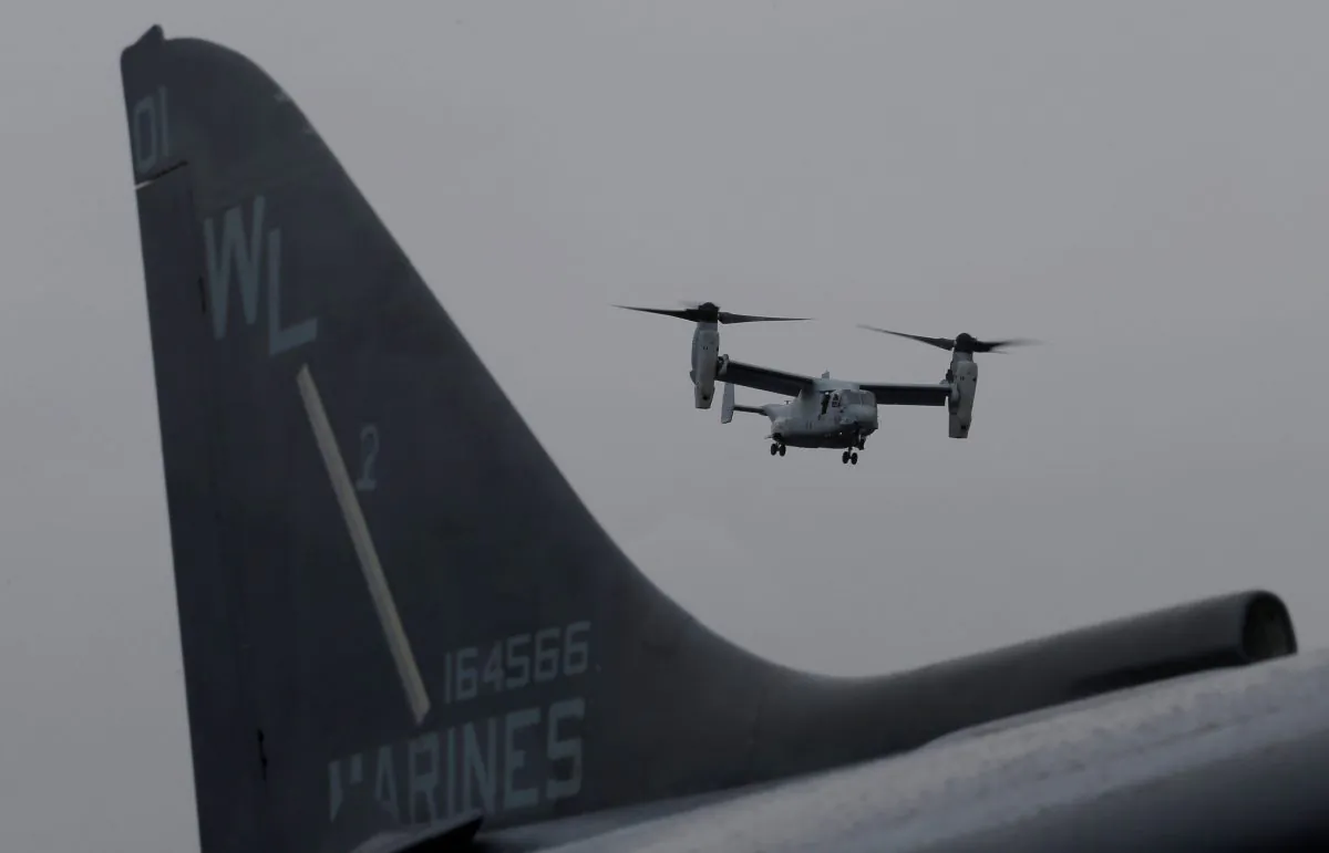 File photo of a U.S. Marines MV-22 Osprey Aircraft flies over a jet before landing on the deck of the USS Bonhomme Richard amphibious assault ship off the coast of Sydney, Australia June 29, 2017. (Reuters/Jason Reed/File Photo)