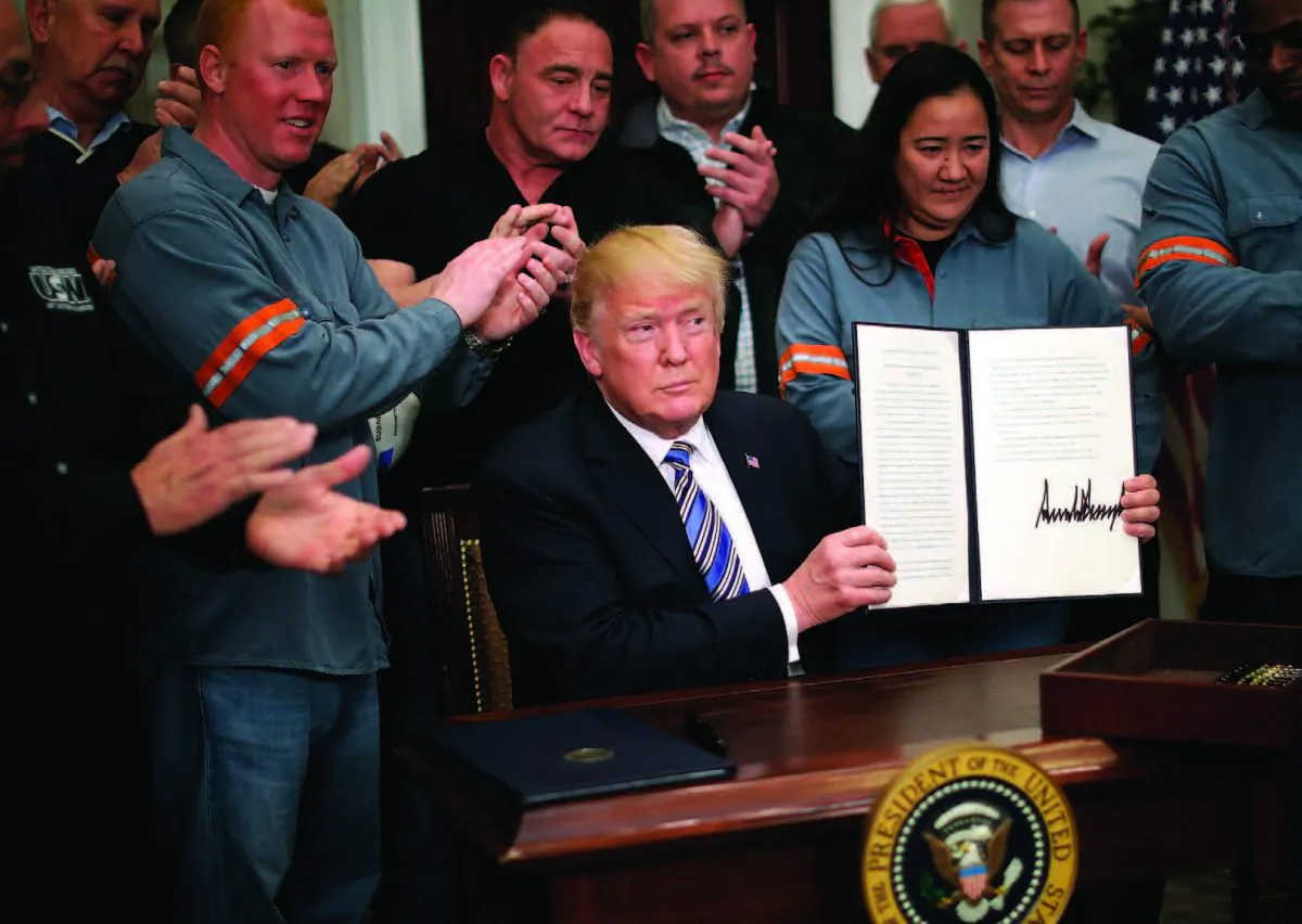 Surrounded by steel and aluminum workers, President Donald Trump signs a Section 232 proclamation on steel imports at the White House on Mar. 8, 2018. Trump ordered a 25 percent tariff on imported steel and a 10 percent tariff on imported aluminum. (CHIP SOMODEVILLA/GETTY IMAGES) 