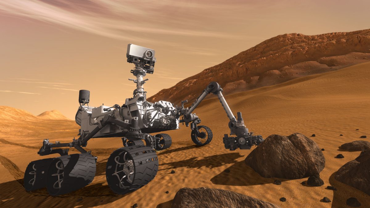 This is what the Curiosity might look like, rolling across Martian terrain, gathering data. (NASA/JPL-Caltech)