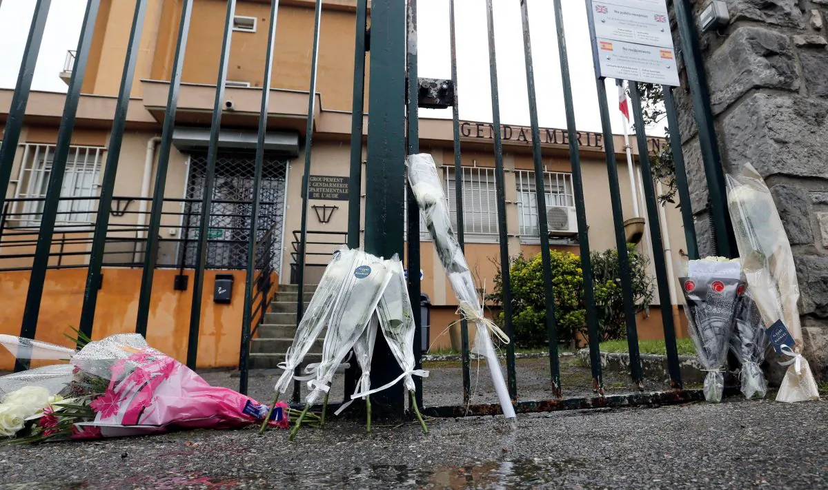 Flowers and messages in tribute to victim are seen in front of the Gendarmerie of Carcassonne, the day after a hostage situation in Trebes, France March 24, 2018. (Reuters/Regis Duvignau)
