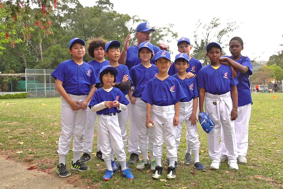 Patrick Calkins (coach) together with some of his “Tai Po Indians” baseball team that played the league leaders “Bombers” in the HK Baseball Association’s new Coach Pitch league at Fanling on Saturday March 17, 2018. (Bill Cox)