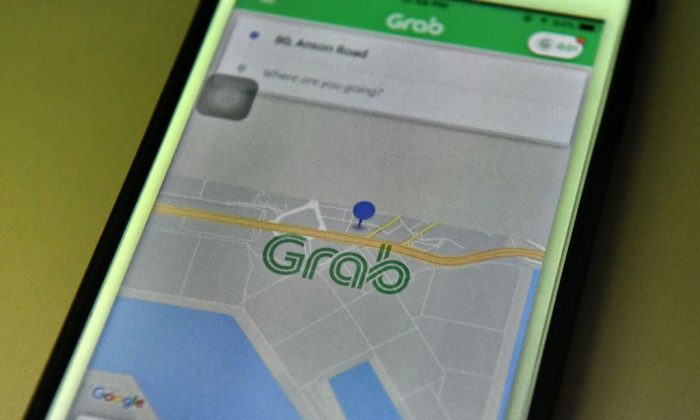 This photo illustration taken on March 26, 2018 shows the Grab booking application seen on a smart phone in Singapore. 
(Roslan Rahman/AFP/Getty Images)