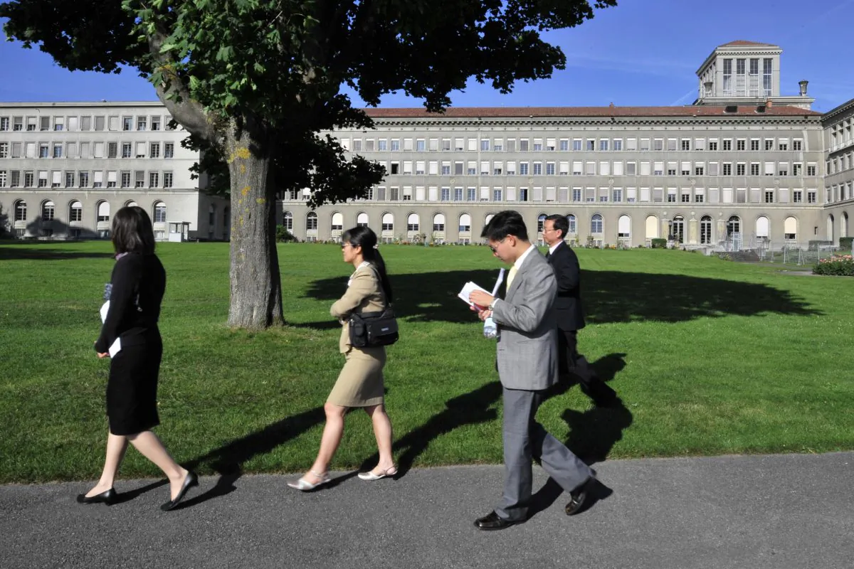 Chinese officials walk in front the World Trade Organization headquarters on July 22, 2008 in Geneva. (Fabrice Coffrini/AFP/Getty Images)