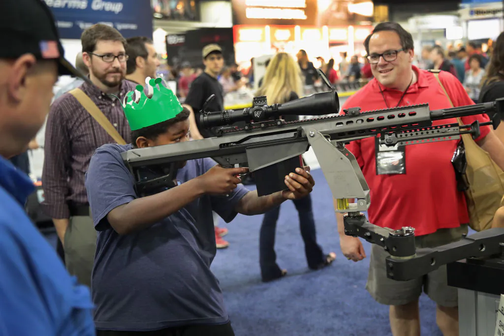 National Rifle Association members look over guns in the Barrett display at the 146th NRA Annual Meetings & Exhibits in Atlanta, Georgia, on April 29, 2017. With more than 800 exhibitors, the convention is the largest annual gathering for the NRA's more than 5 million members. (Scott Olson/Getty Images)