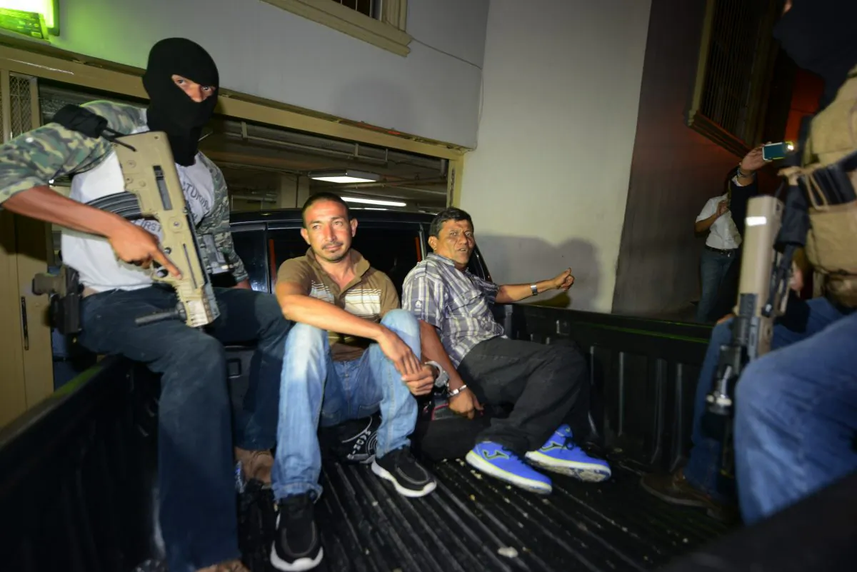 Police take two presumed members of a gang trafficking people to the United States to court in Tegucigalpa, Honduras on June 9, 2016. (ORLANDO SIERRA/AFP/Getty Images)
