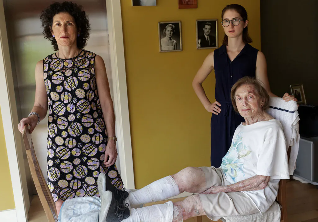 Dr. Rita Redberg (left), director of women's cardiovascular services at the University of California-San Francisco Division of Cardiology; her mother, Mae Redberg (seated); and her daughter, Anna Larson, pose for a portrait in Mae's apartment in Manhattan in October 2017. Dr. Redberg struggles to stop other doctors from performing too many procedures on Mae, who is 92. “We have a culture that believes in very aggressive care,” Redberg says. “We are often not considering the chance of benefit and chance of harm, and how that changes when you get older. We also fail to have conversations about what patients value most.” (Photo by Yana Paskova for Kaiser Health News)
