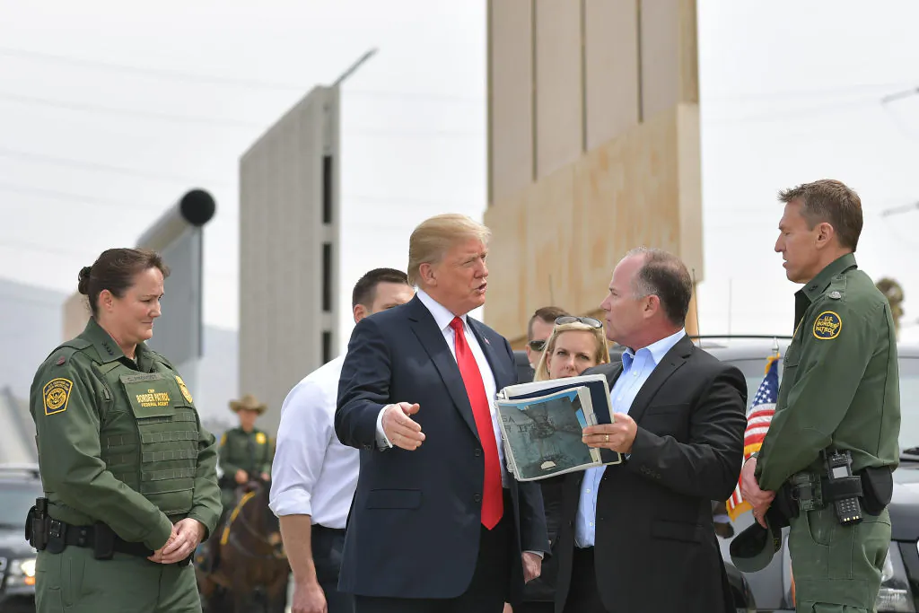 US President Donald Trump (C) is shown border wall prototypes in San Diego, California on March 13, 2018. (MANDEL NGAN/AFP/Getty Images)