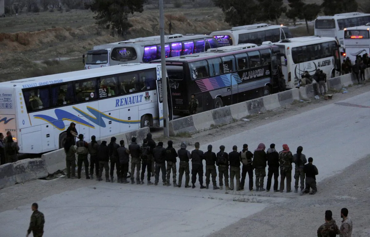 Rebel fighters pray before they are evacuated, outside Harasta in eastern Ghouta, in Damascus, Syria March 23, 2018. (Reuters/Omar Sanadiki)