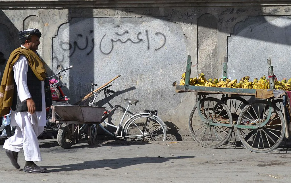 A Pakistani pedestrian walks past a wall graffiti which reads Daesh, the arabic acronym for ISIS, in Quetta in Baluchistan province on November 24, 2014. (Banaras Khan/AFP/Getty Images)