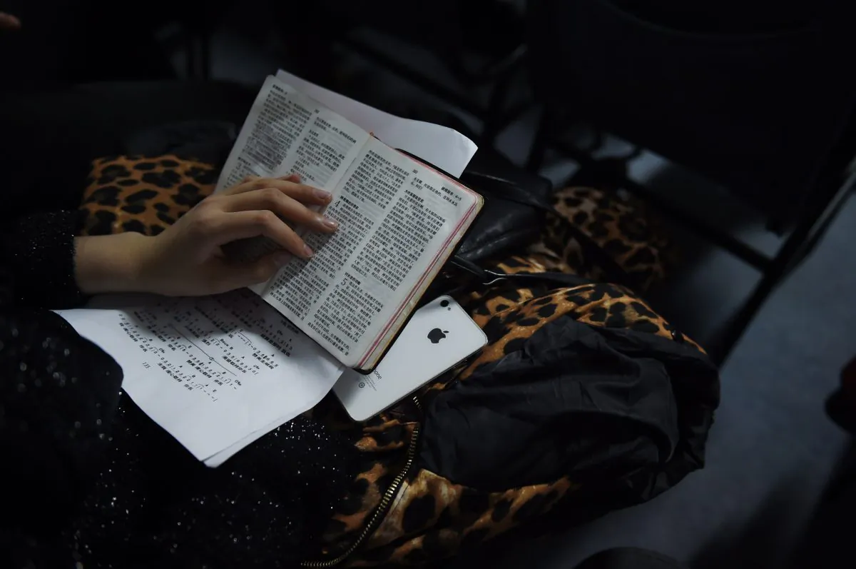 A member of an underground church holds a Bible during a Christmas Eve service at an apartment in Beijing on Dec. 24, 2014.  (Greg Baker/AFP/Getty Images)