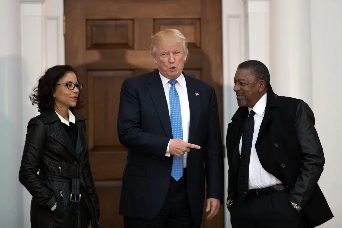 President-elect Donald Trump (C) greets Robert Johnson (R), the founder of Black Entertainment Television, and his wife Lauren Wooden (L) as they arrive for a meeting with president-elect Donald Trump at Trump International Golf Club, November 20, 2016 in Bedminster Township, New Jersey. (Drew Angerer/Getty Images)