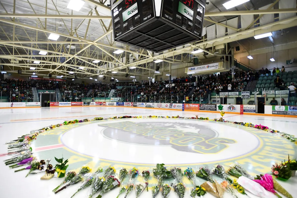 Flowers lie on the ice as people gather for a vigil at the Elgar Petersen Arena, home of the Humboldt Broncos, to honour the victims of a fatal bus accident in Humboldt, Saskatchewan, April 8, 2018. (Jonathan Hayward/Pool via Reuters)