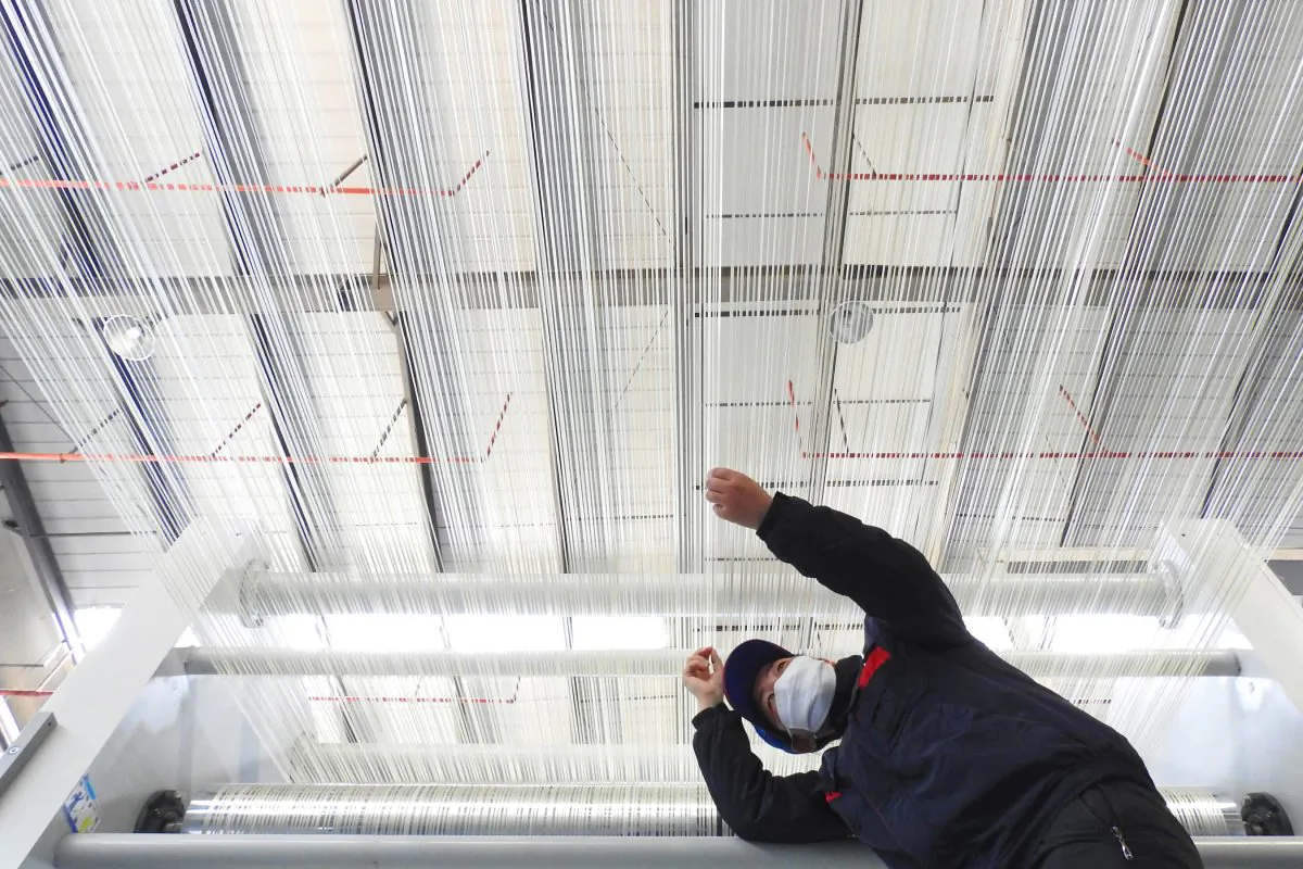 An employee works on a T1000 carbon fiber production line at a factory in Lianyungang in China's eastern Jiangsu Province on Feb. 27, 2018. -/AFP/Getty Images)