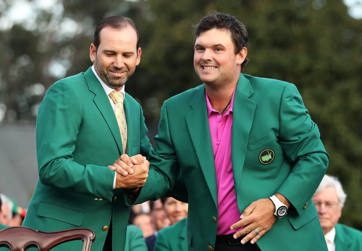 Patrick Reed (R) is congratulated by Sergio Garcia after being presented the green jacket for winning the 2018 Masters Tournament at Augusta National Golf Club on April 8, 2018 in Augusta, Georgia. (Patrick Smith/Getty Images)