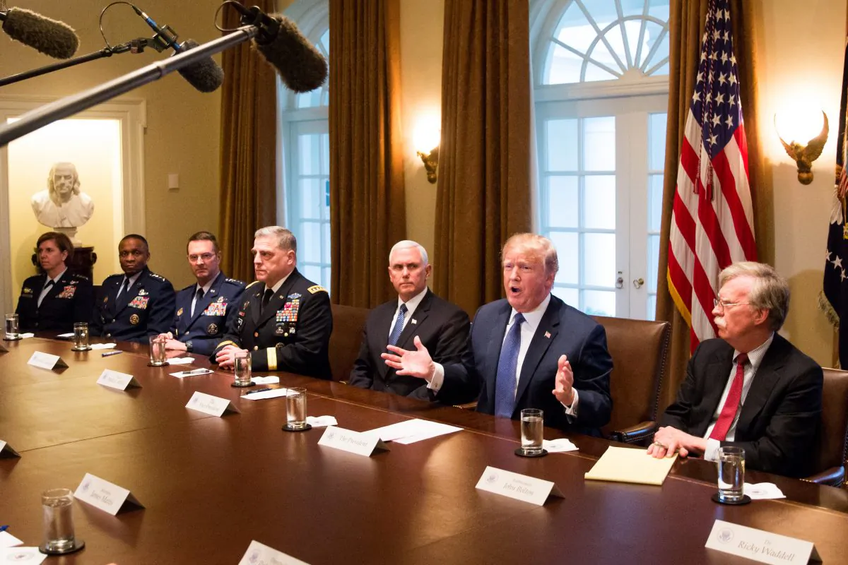 President Donald Trump speaks during a meeting with senior military leaders while flanked by Vice President Mike Pence (L) and National Security Advisor John Bolton (R) in the Cabinet Room of the White House in Washington on April 9, 2018. (Samira Bouaou/The Epoch Times)