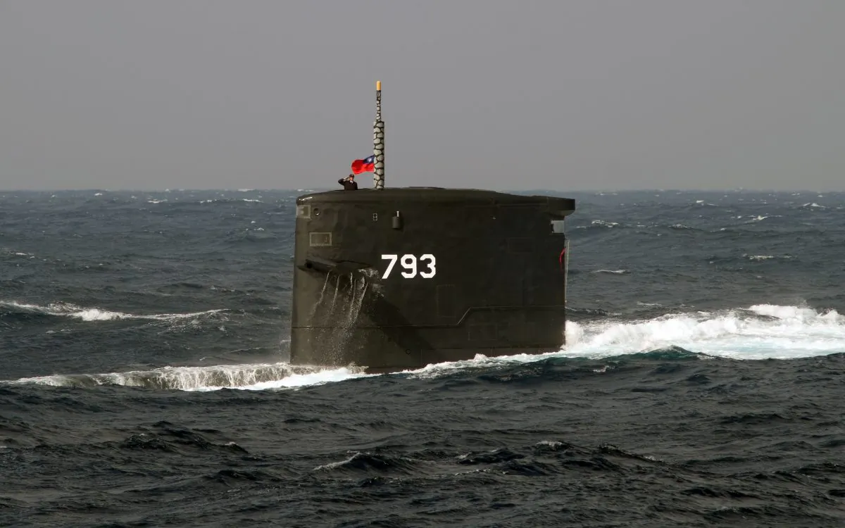 A Taiwanese navy soldier salutes from the Dutch-made Chien Lung-class submarine during a combat skills demonstration in the waters near the Tsoying navy base in southern Kaohsiung, Taiwan on Jan. 14, 2014. (Sam Yeh/AFP/Getty Images)
