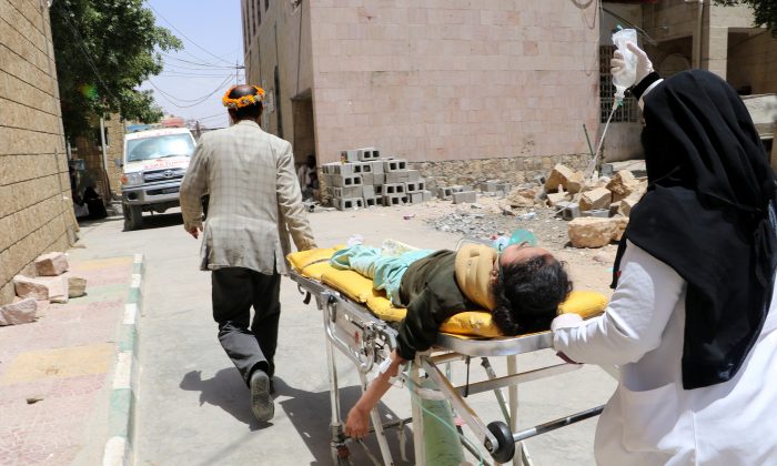 A school girl is being rushed on a stretcher to a hospital after she was injured by an airstrike near her school in Saada, Yemen April 9, 2018. (Reuters/Naif Rahma)