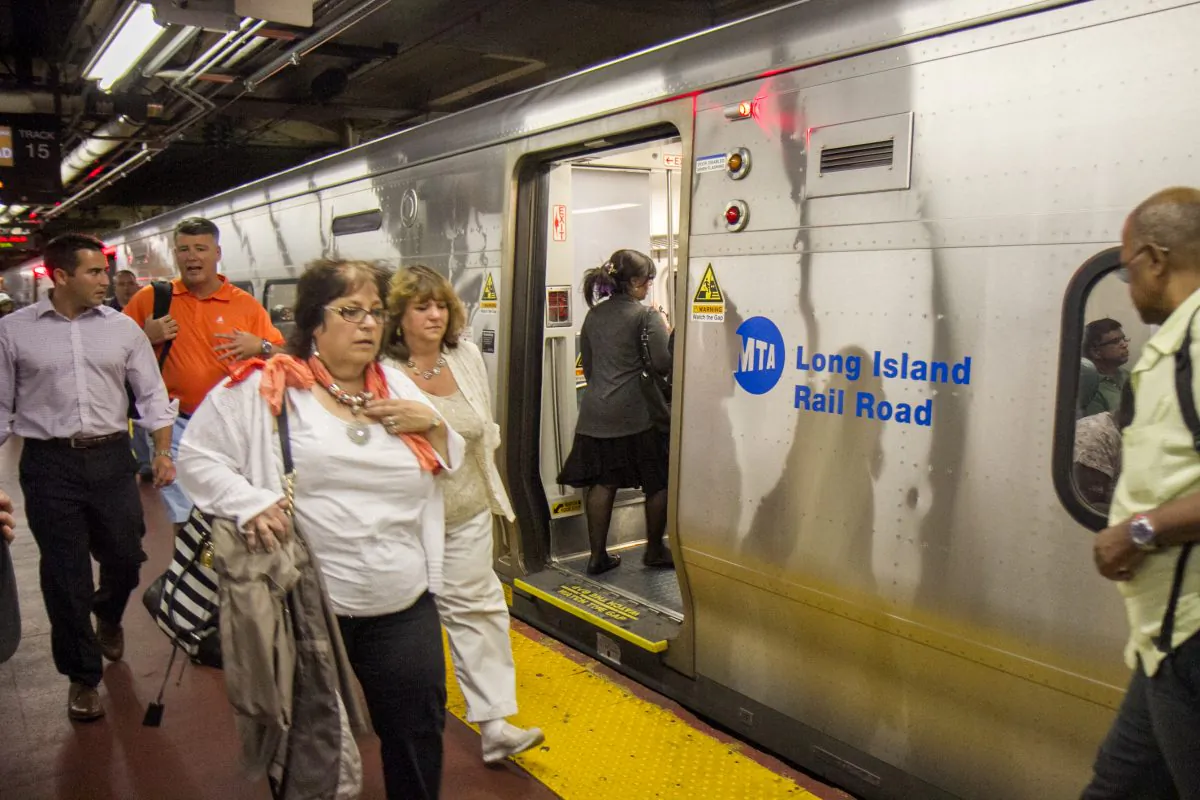 Commuters board a Long Island Rail Road train at Penn Station in New York City. (Benjamin Chasteen/Epoch Times)