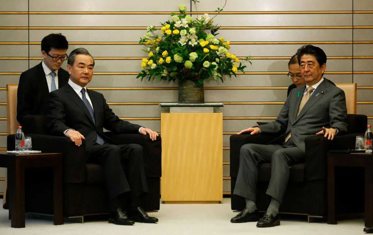 China's Foreign Minister Wang Yi (L) meets with Japan's Prime Minister Shinzo Abe at Abe's official residence in Tokyo on April 16, 2018. (Toru Hanai/AFP/Getty Images)