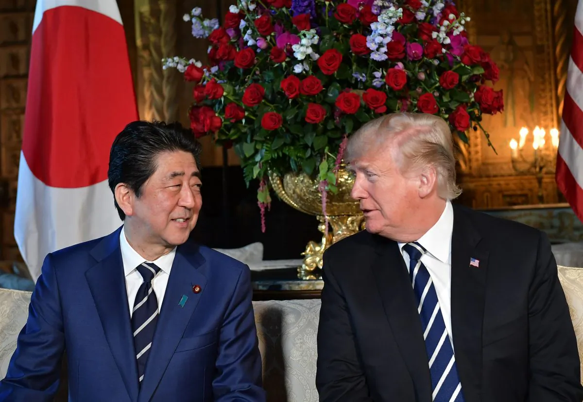 President Donald Trump greets Japanese Prime Minister Shinzo Abe as he arrives for talks at Trump's Mar-a-Lago resort in Palm Beach, Florida, on April 17, 2018. (MANDEL NGAN/AFP/Getty Images)