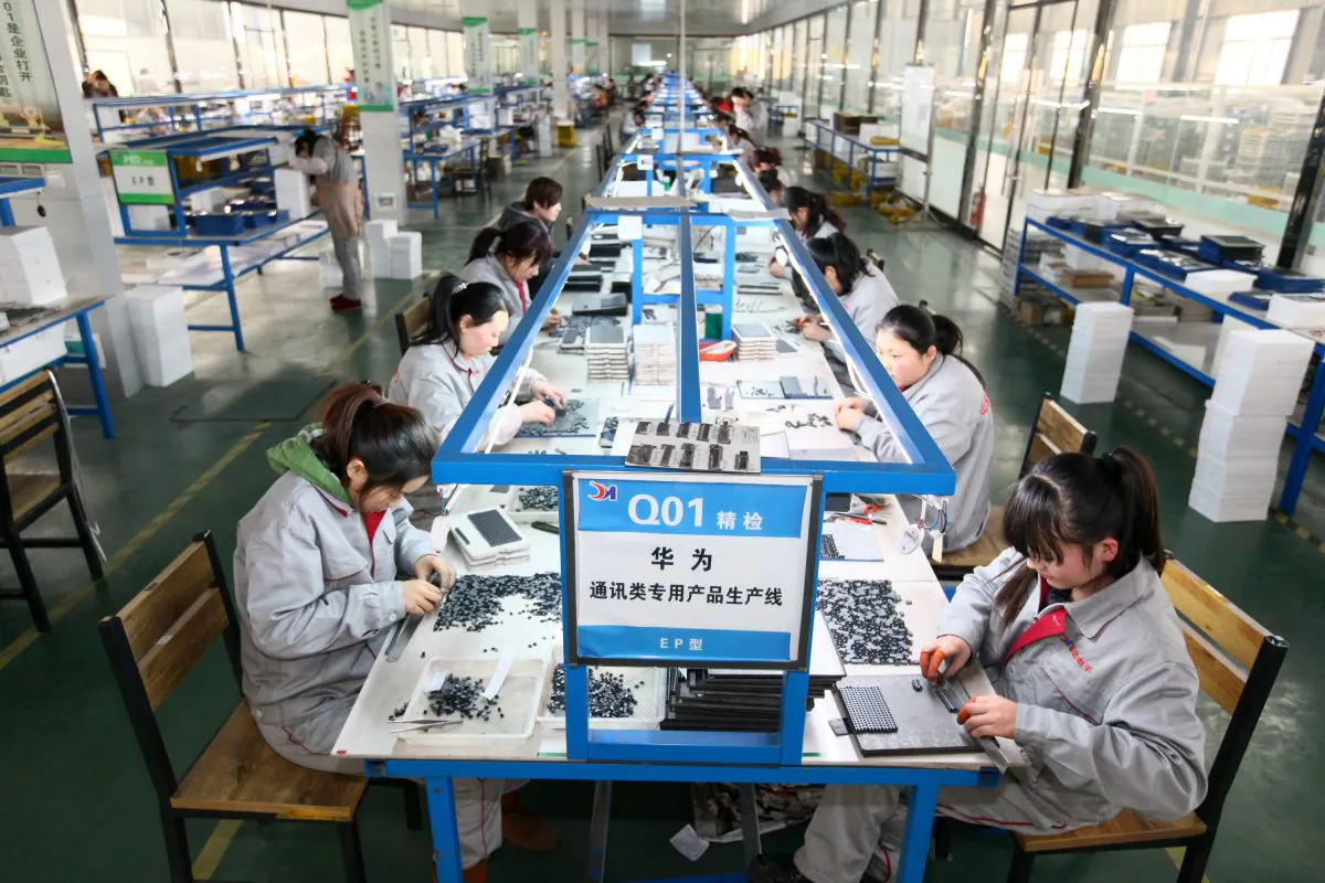 Workers at an electronics company in Tengzhou, in China's eastern Shandong Province, on Feb. 1, 2016. (STR/AFP/Getty Images)