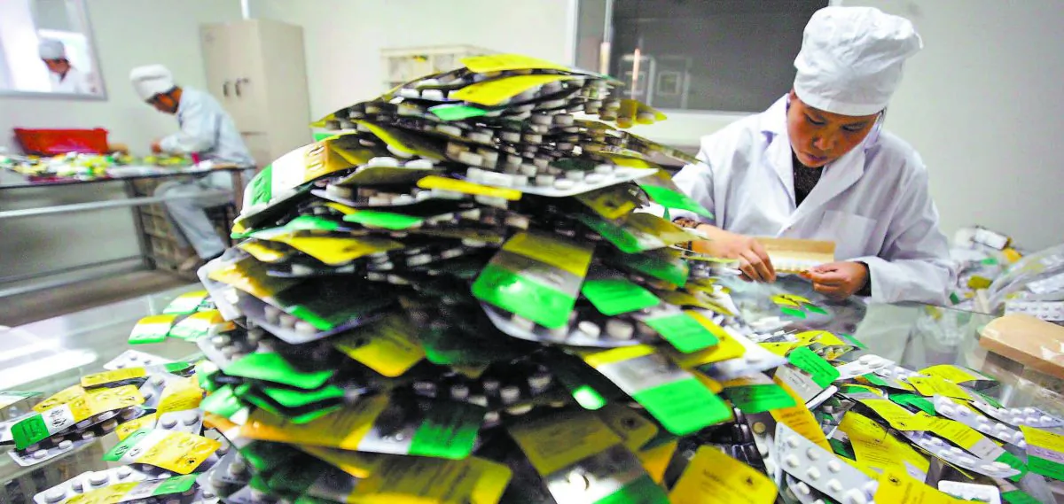 Workers package malaria pills at Guilin Pharmaceutical in Guilin, China, in this file photo. (FREDERIC J. BROWN/AFP/GETTY IMAGES) 