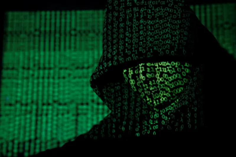 Cyber code on a hooded man on May 13,  2017. (Reuters/Kacper Pempel/Illustration)