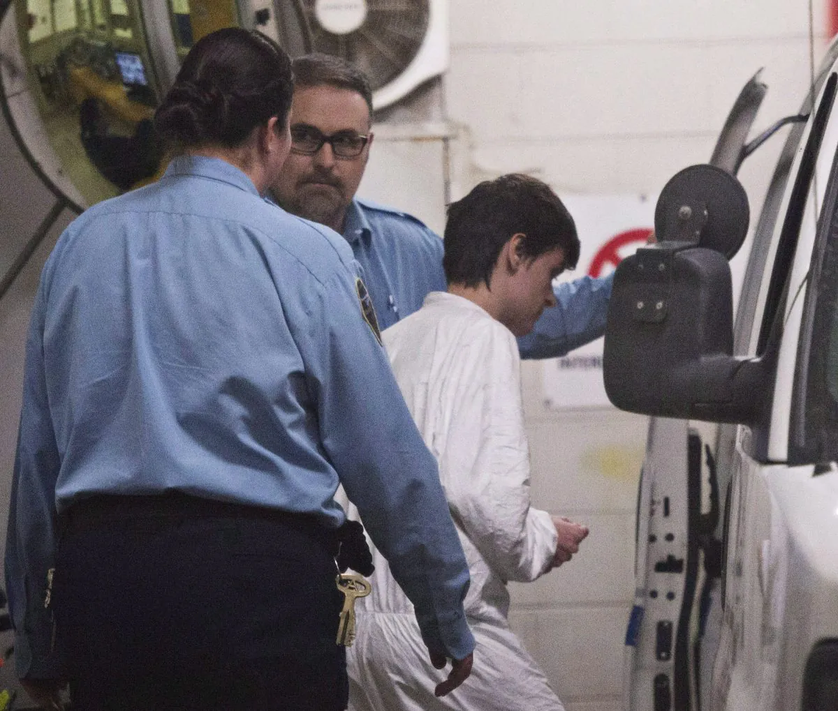 Alexandre Bissonnette is escorted to a van on Jan. 30, 2017, after appearing in court in Quebec City for a deadly shooting at a Quebec mosque. (The Canadian Press/Jacques Boissinot)