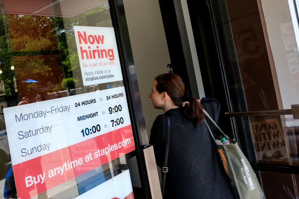 A 'now hiring' sign is displayed on the front entrance to a Staples store in New York City, June 2, 2017. (Drew Angerer/Getty Images)