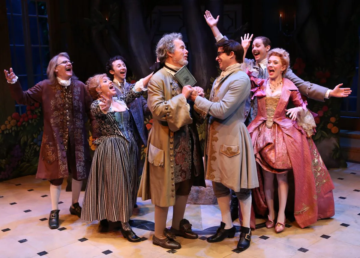 (L–R) Peter Kybart, Dina Thomas, Adam Green, Adam LaFevre, Christian Conn, Noah Averbach-Katz, and Amelia Pedlow, in a scene from David Ives's “The Metromaniacs.” (Carol Rosegg)