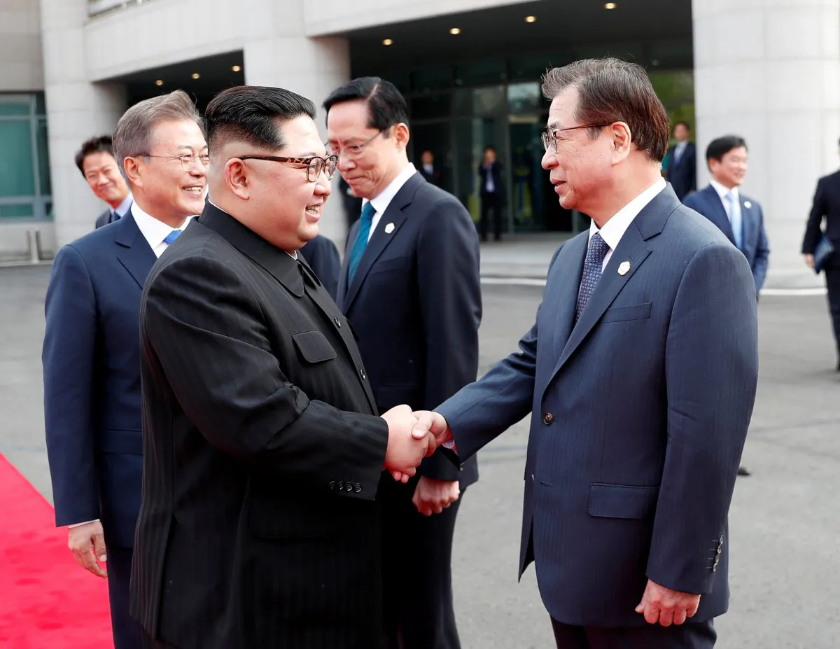 North Korean leader Kim Jong Un 
(R) shakes hands with Suh-hoon, South Korea's chief of the National Intelligence Service (NIS) at the truce village of Panmunjom inside the demilitarized zone separating the two Koreas on April 27, 2018. (Korea Summit Press Pool/via Reuters)